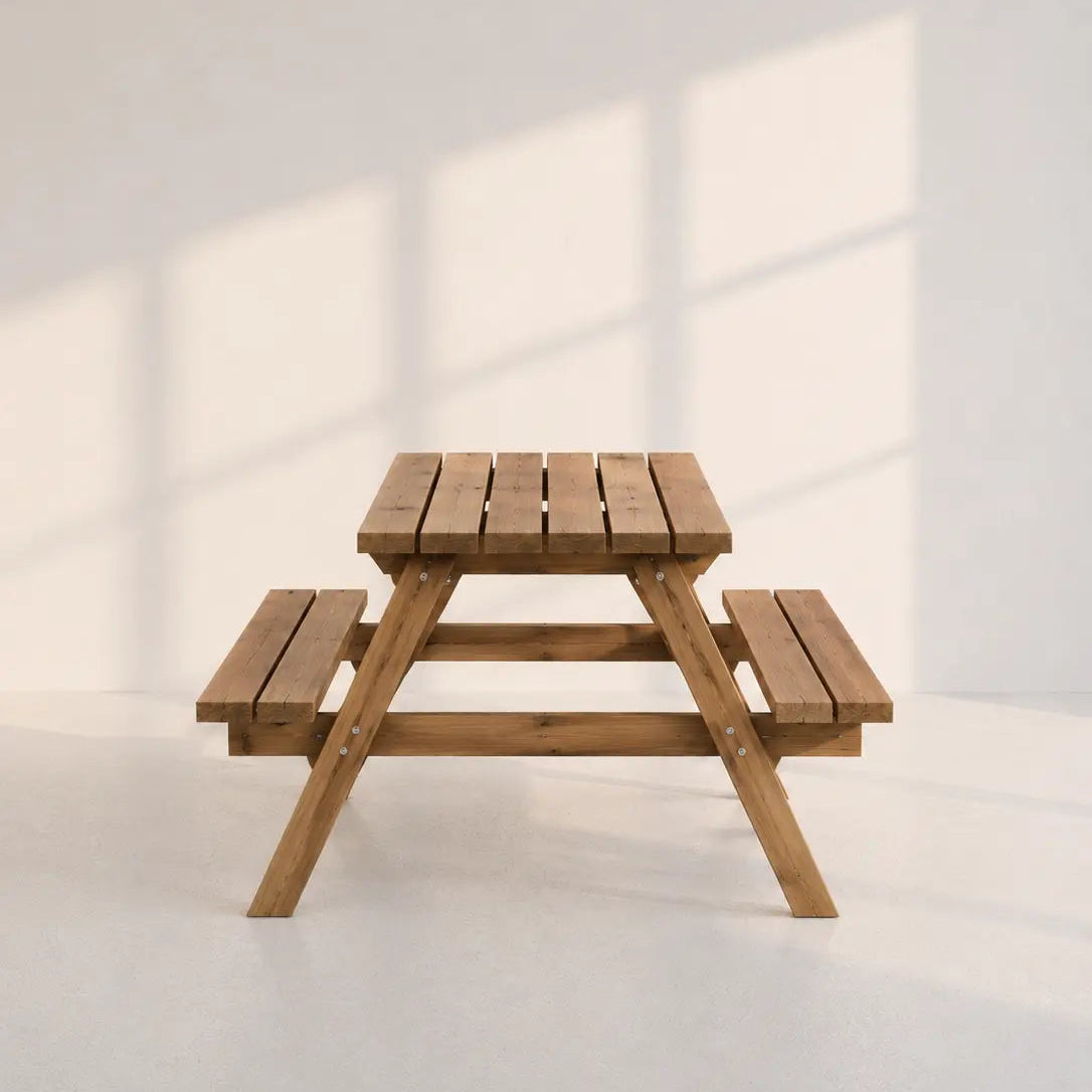 Image of A small wooden picnic table with attached benches, shown in a minimalist studio setting with soft window-box shadows on a light gray background.