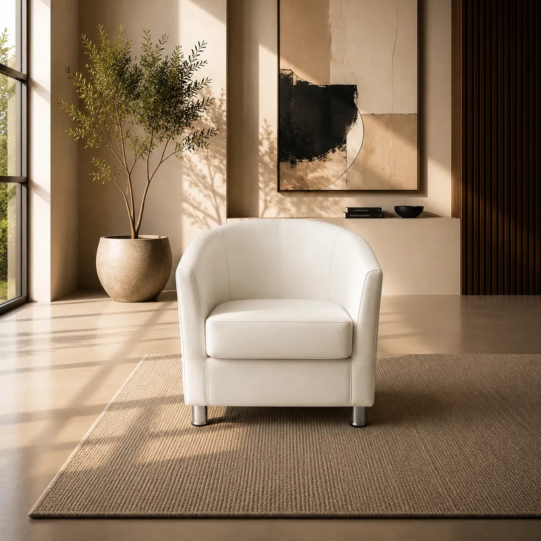 Image of A modern white leather armchair sits on a textured beige rug in a sunlit minimalist living room. A large abstract wall art piece hangs above, with a potted plant to the left and warm recessed lighting in the background.