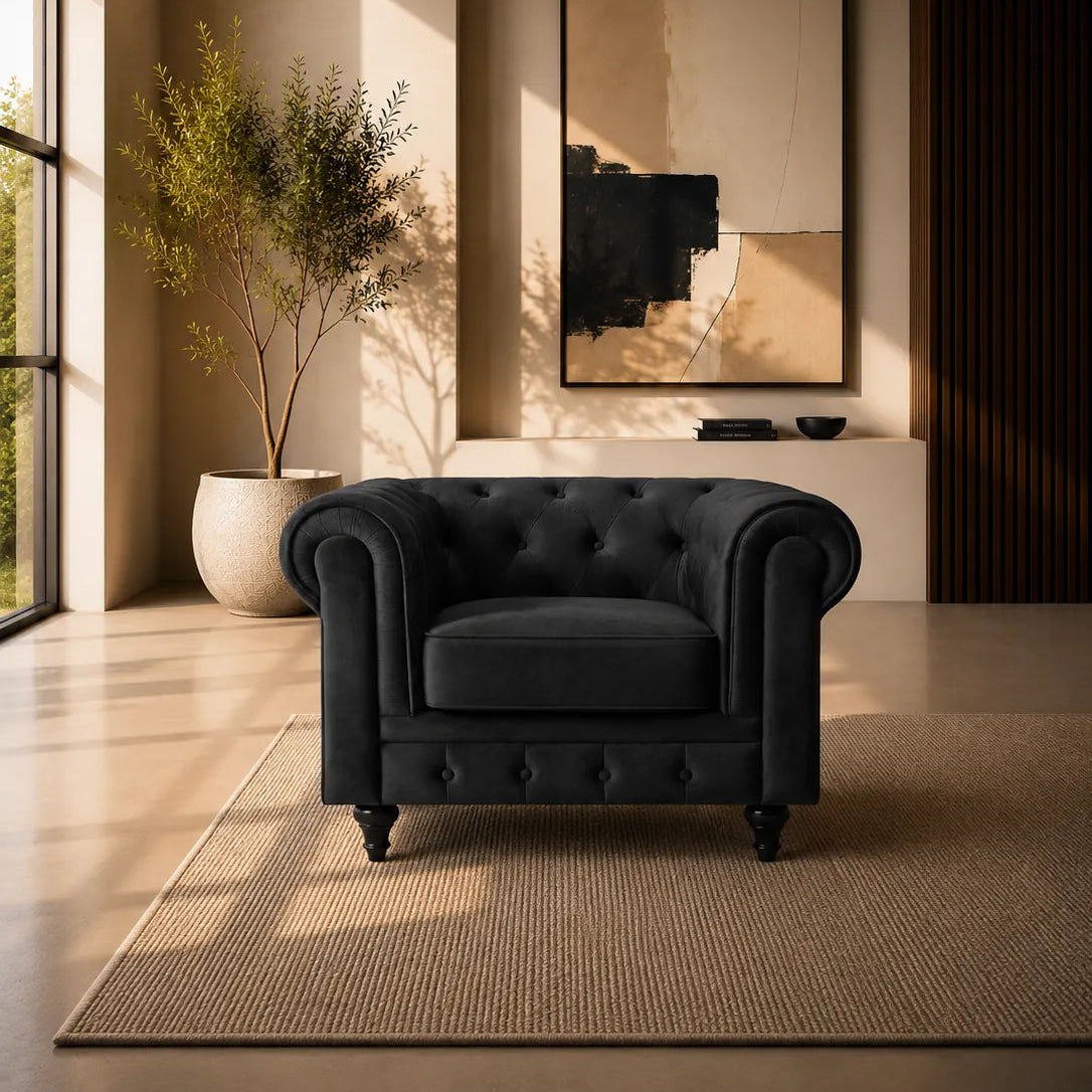 Image of A black tufted armchair in a modern, sunlit living room with beige walls, a large framed abstract print, a potted plant, and a woven rug.