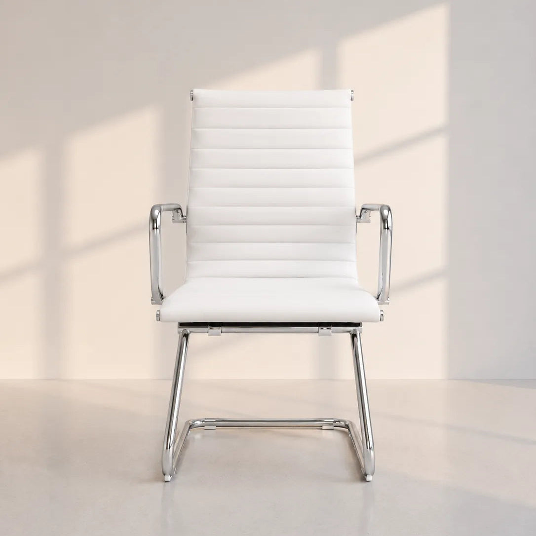 Image of A modern white faux-leather office chair with a ribbed backrest, chrome metal armrests, and a chrome four-star base, set against a minimalist light beige wall with soft window shadow projections.