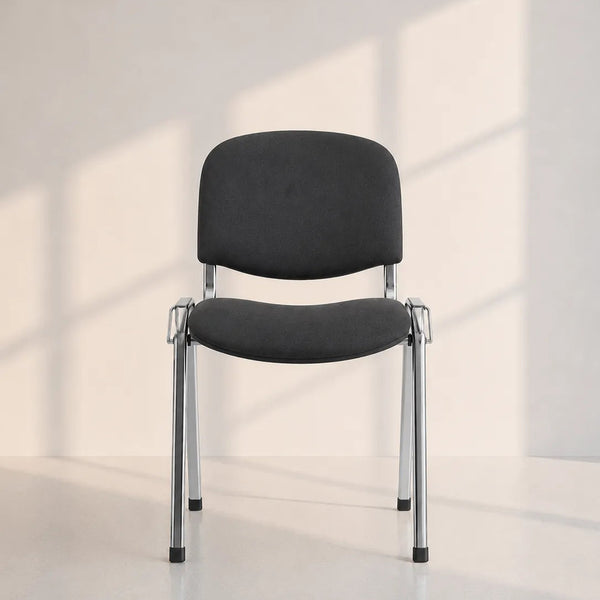 A modern black upholstered chair with a chrome metal frame, positioned in a minimalist room with soft window-box shadows cast on a light beige wall and floor.
