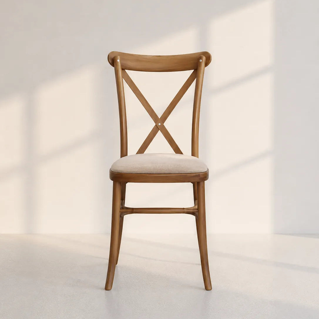 Image of A wooden dining chair with a light beige upholstered seat cushion, positioned against a minimalist off-white wall with soft window shadow patterns.