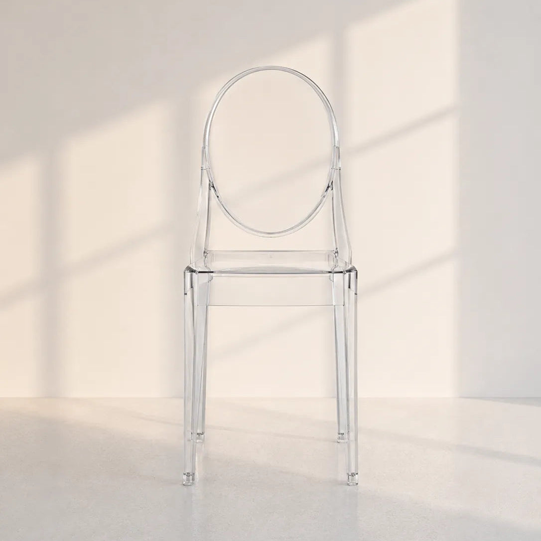 Image of A transparent acrylic dining chair with a rounded backrest, shown in a minimalist room with soft window shadow light.