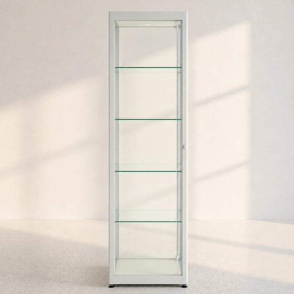 A tall, narrow white glass display cabinet with five shelves, shown in a minimalist room with soft window shadows.