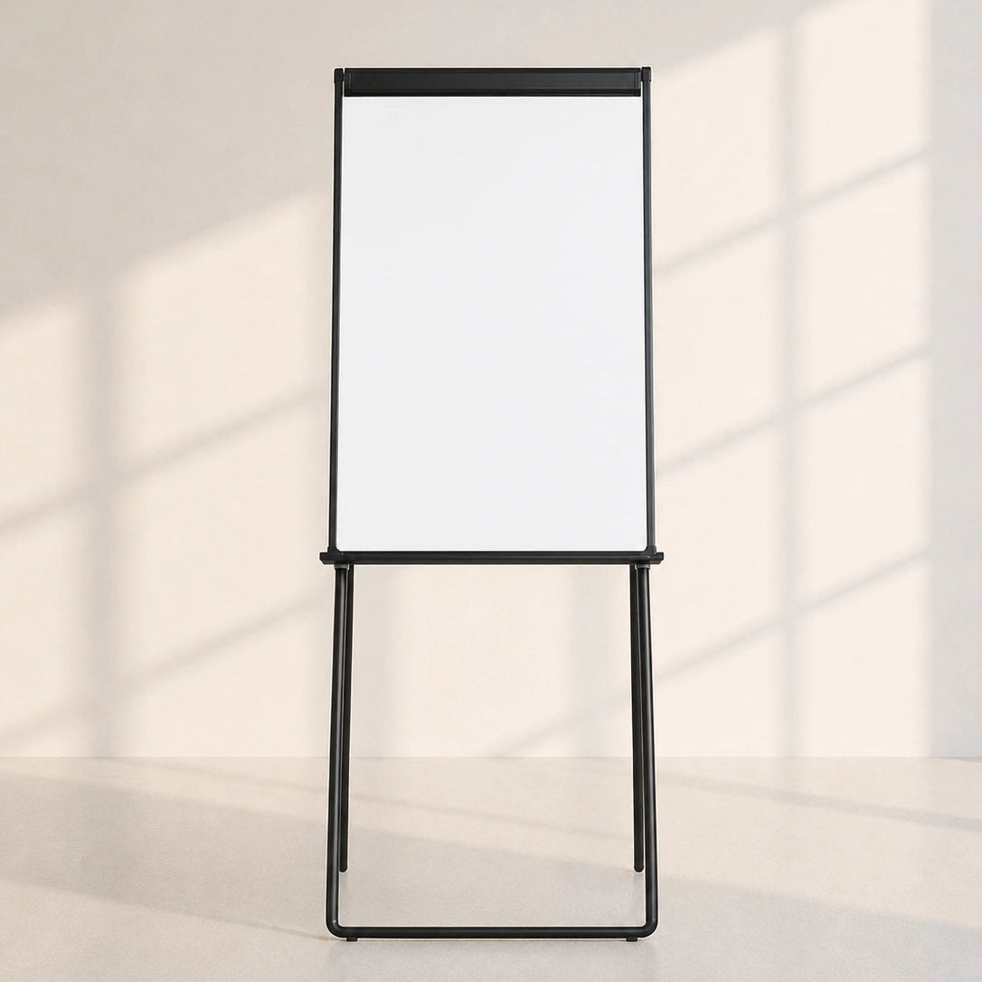 Image of A black metal freestanding whiteboard on a matching stand, shown against a warm off-white wall with soft window shadow patterns.