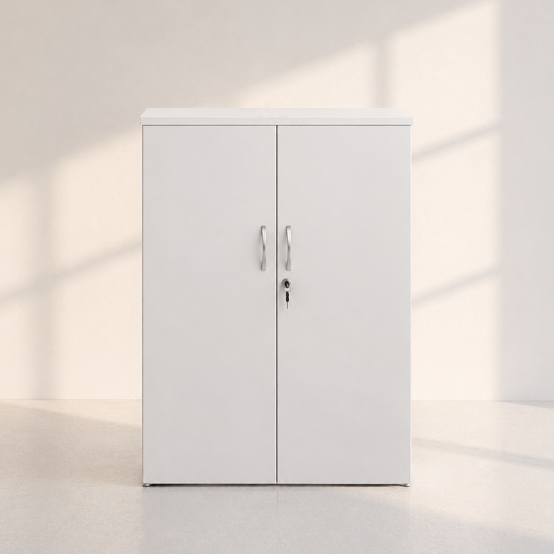 Image of A white two-door storage cabinet with silver handles and a lock, set against a minimalist off-white wall and floor with soft window shadow light.