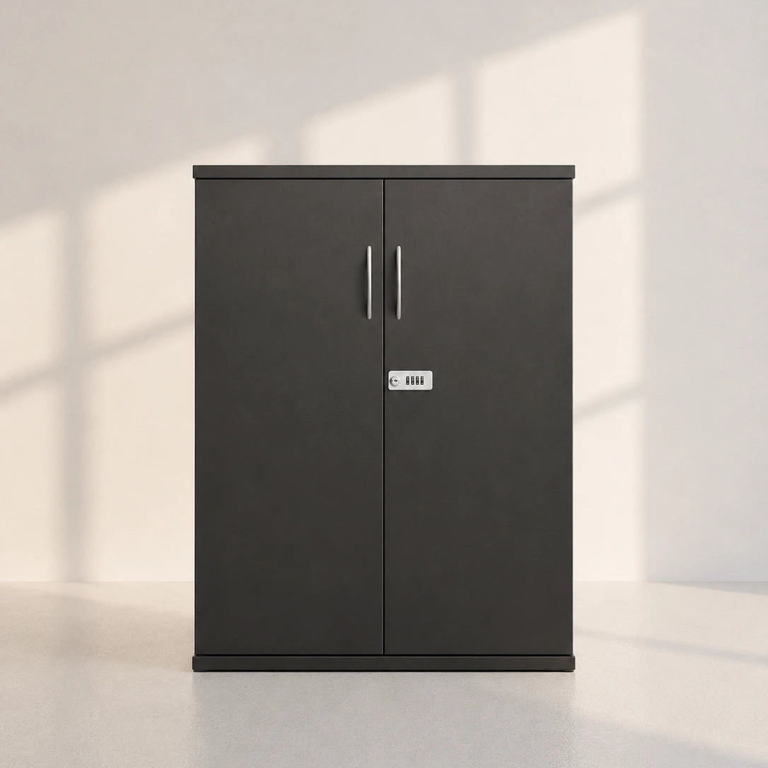 Image of A tall, dark gray two-door cabinet with slim vertical handles and a small silver lock, positioned against a light gray wall with soft window shadow patterns.