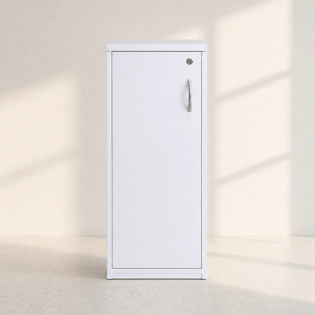 Image of A tall, white metal storage cabinet with a single door, a silver vertical handle, and a small round lock, set against a minimalist beige wall with soft window shadow patterns.