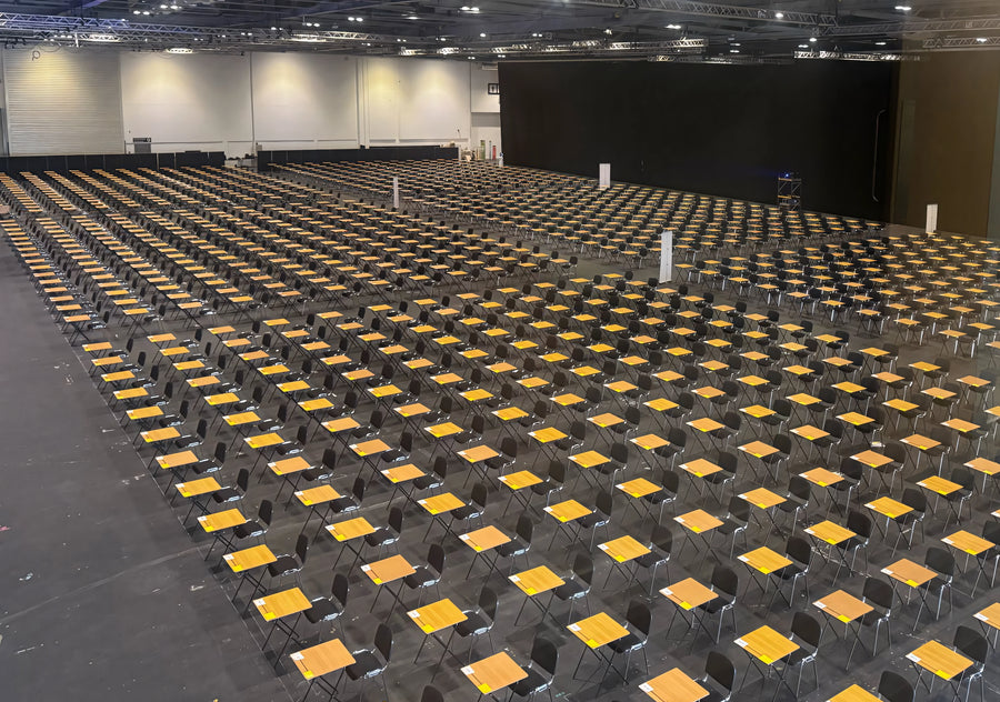 Exam hall set with rows of exam desks and chairs