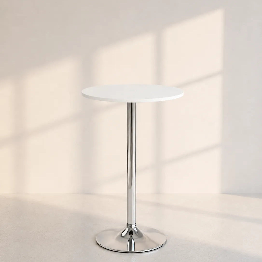 A modern round side table with a white top and a polished chrome pedestal base, set against a minimalist beige wall with soft window shadow patterns.