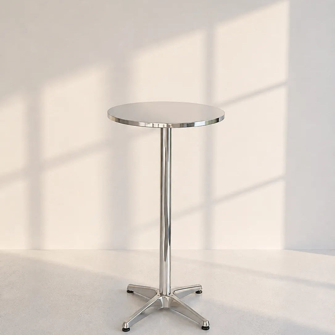 Image of A modern round bar table with a polished chrome pedestal base and star-style legs, set against a minimalist off-white wall with soft window shadow patterns.