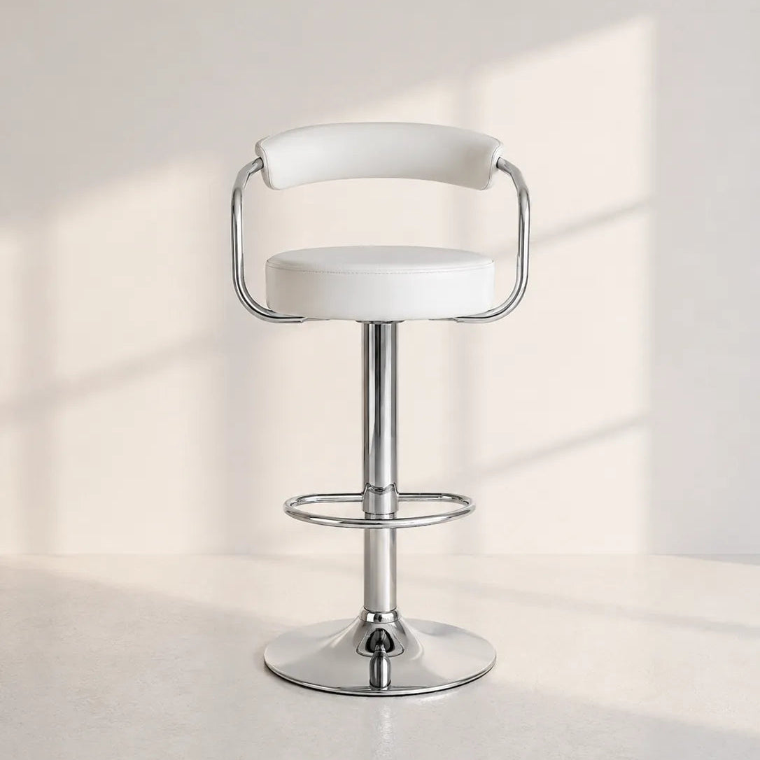 Image of A modern bar stool with a white upholstered seat and curved backrest, supported by a polished chrome pedestal base and footrest, set against a minimalist off-white wall with soft window-light shadows.
