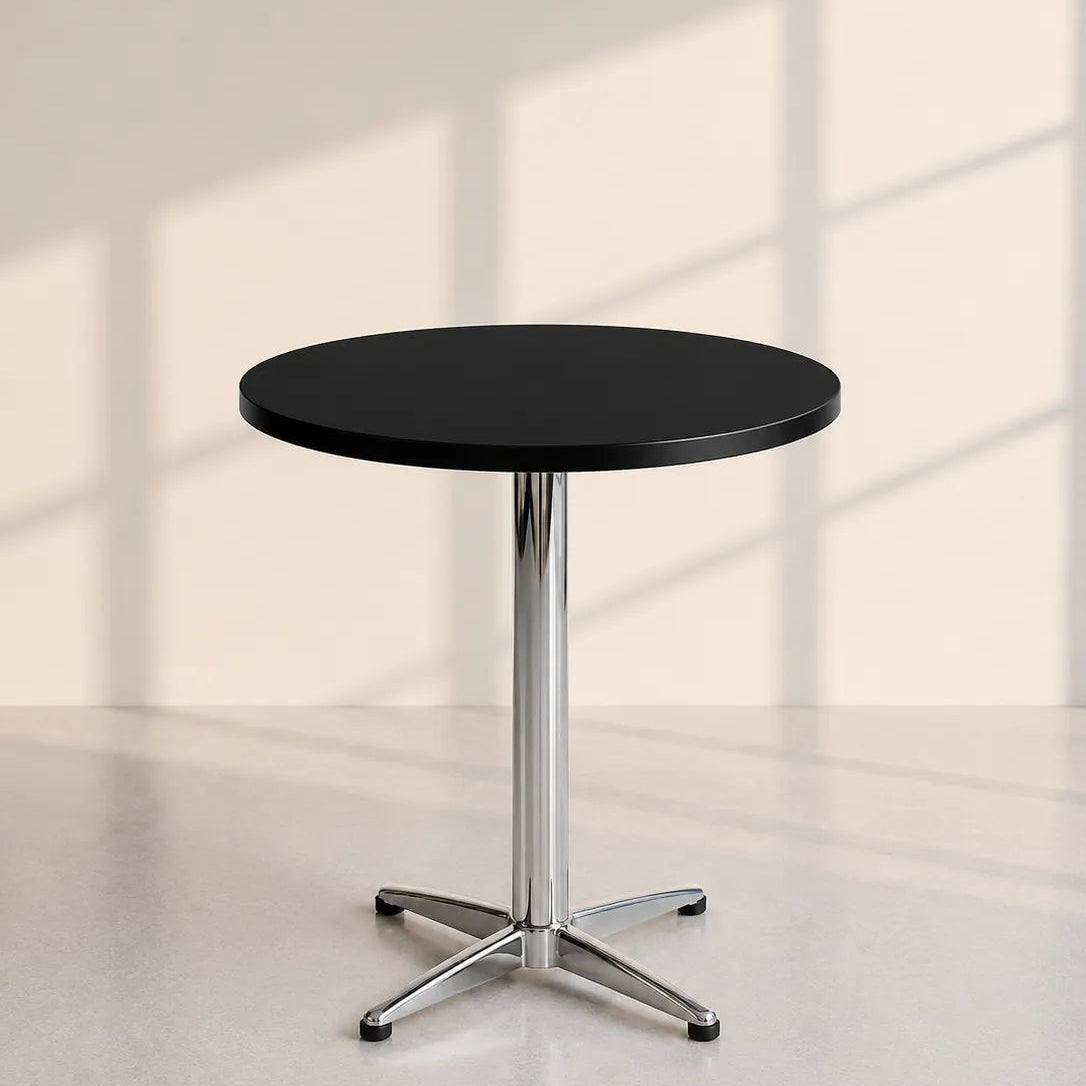 Image of A round black cafe table with a chrome star base, set against a minimalist beige wall with soft window shadow patterns.